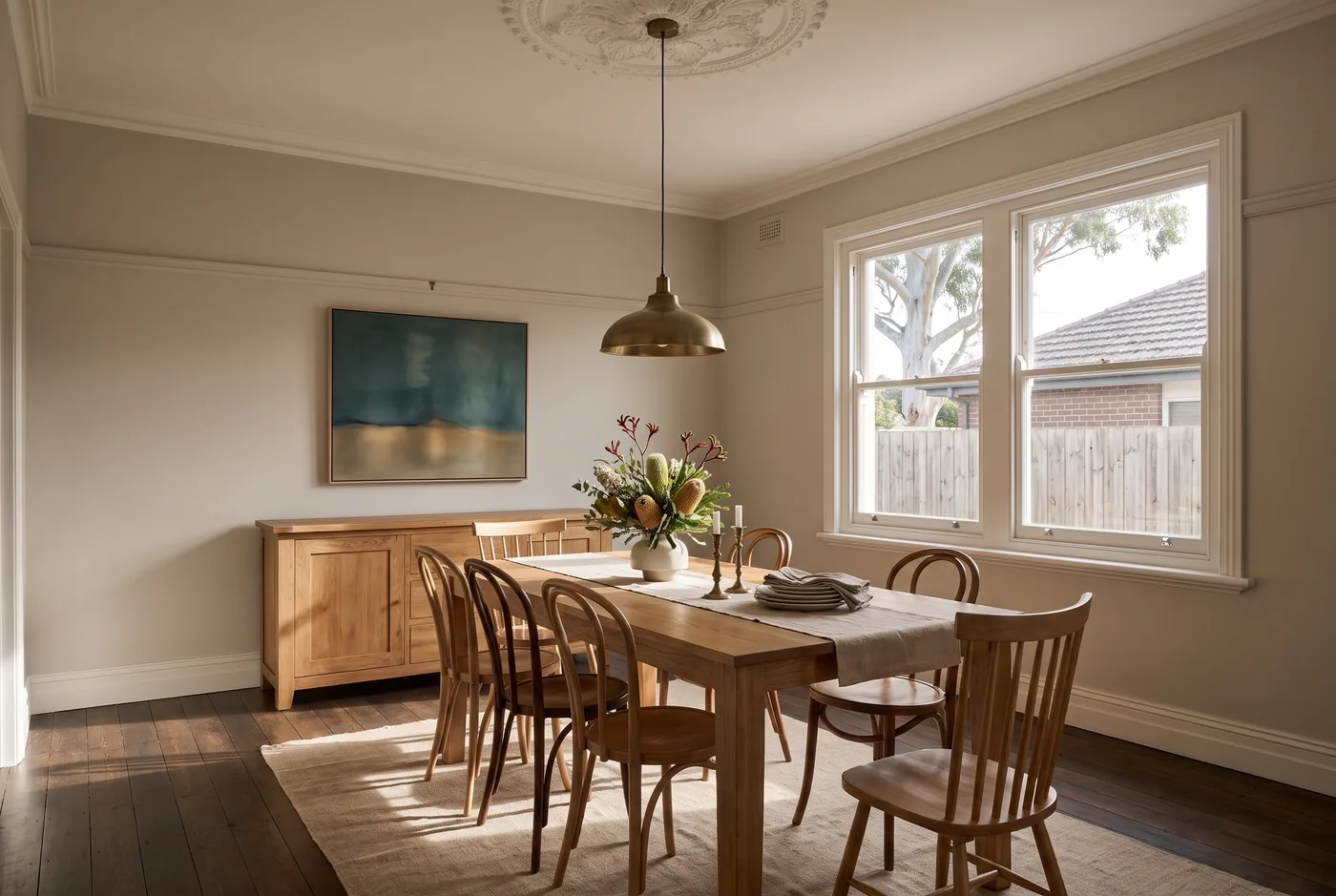 An orderly dining space with a timber table and upholstered chairs.